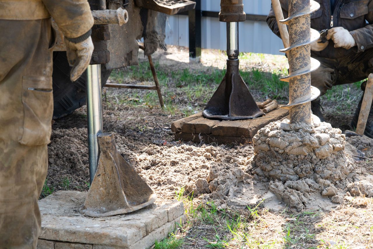 An Evans Well Drilling auger drilling a new water well into dry, sandy ground in Southern Idaho.